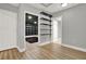 An open room featuring luxury vinyl plank flooring, neutral walls and built-in shelves at 271 Brooks Rackley Rd, Dallas, GA 30157