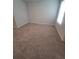 A bright bedroom with neutral carpet and a window for natural light at 558 Fairview Oak Pl, Dallas, GA 30157