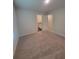 Open bedroom area featuring soft carpeting with the bathroom visible through the door at 558 Fairview Oak Pl, Dallas, GA 30157
