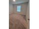 A bright bedroom with neutral carpet and a window for natural light at 558 Fairview Oak Pl, Dallas, GA 30157