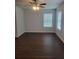 Bedroom featuring neutral walls, two large windows, and a modern ceiling fan at 558 Fairview Oak Pl, Dallas, GA 30157