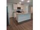 Bright kitchen features stainless steel appliances, granite countertops and a center island at 558 Fairview Oak Pl, Dallas, GA 30157