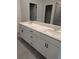 Bathroom vanity featuring double sinks, modern hardware and tiled flooring at 616 Rodeo Dr, Auburn, GA 30011