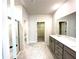 Bathroom vanity area featuring a shower and a walk in closet at 616 Rodeo Dr, Auburn, GA 30011