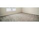 A carpeted bedroom with a window showing an outdoor view at 616 Rodeo Dr, Auburn, GA 30011