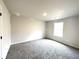 Bedroom with plush carpet, neutral walls, one window, and a ceiling light at 616 Rodeo Dr, Auburn, GA 30011