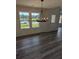 Dining room featuring stylish chandelier, luxury vinyl plank flooring, and abundant natural light at 616 Rodeo Dr, Auburn, GA 30011