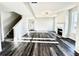 Open living room with fireplace, luxury vinyl plank flooring, and a staircase at 616 Rodeo Dr, Auburn, GA 30011