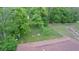 Aerial view of an overgrown backyard with trees and a shed at 1934 Apache Se Trl, Atlanta, GA 30316