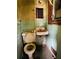 Old bathroom with mint tiles featuring a toilet, sink, and window at 1934 Apache Se Trl, Atlanta, GA 30316