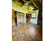 Damaged bedroom featuring hardwood floors, exposed ceiling beams, and a ceiling fan at 1934 Apache Se Trl, Atlanta, GA 30316