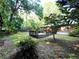Landscaped backyard with mature trees and a wooden deck, perfect for outdoor entertaining at 2225 Harold Se Ln, Smyrna, GA 30080