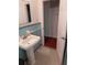Classic bathroom features a pedestal sink, tiled walls, patterned floor, and a traditional aesthetic at 2225 Harold Se Ln, Smyrna, GA 30080