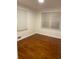 Bedroom with wood floors, large windows, and neutral paint offers versatility and comfort at 2225 Harold Se Ln, Smyrna, GA 30080
