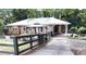 Brick home with a metal roof and a covered carport, showcasing a fenced yard with mature landscaping at 2225 Harold Se Ln, Smyrna, GA 30080