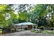 Charming brick home featuring a covered entrance, gazebo, and mature trees creating a serene, shaded front yard at 2225 Harold Se Ln, Smyrna, GA 30080