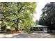 Brick house with a gazebo and covered entrance, set amongst trees in a peaceful, landscaped yard at 2225 Harold Se Ln, Smyrna, GA 30080