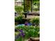 A garden fountain surrounded by lush greenery and vibrant purple flowers at 2225 Harold Se Ln, Smyrna, GA 30080