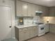 Neutral kitchen with gray cabinets, granite countertops, stainless appliances, and stylish backsplash at 2225 Harold Se Ln, Smyrna, GA 30080