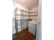 Functional laundry area with storage shelves, washer, and dryer at 2225 Harold Se Ln, Smyrna, GA 30080