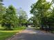 A neighborhood street bordered by mature trees and well-manicured lawns, creating a tranquil setting at 2225 Harold Se Ln, Smyrna, GA 30080