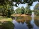 Scenic pond view featuring a tranquil fountain and lush greenery surrounding the water's edge at 2225 Harold Se Ln, Smyrna, GA 30080