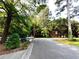 A view of a 'For Sale' sign in a residential neighborhood surrounded by lush trees at 2225 Harold Se Ln, Smyrna, GA 30080