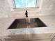 Close up of modern stainless steel sink with speckled countertop and black faucet at 2225 Harold Se Ln, Smyrna, GA 30080