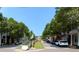 Charming street with mature trees, storefronts, and parked cars under a bright blue sky at 2225 Harold Se Ln, Smyrna, GA 30080