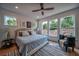 Inviting bedroom with a large bed, multiple windows offering scenic views, and stylish decor at 235 W Marietta St, Canton, GA 30114