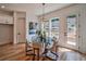 Bright breakfast nook features a glass table, stylish light fixture, and access to the outdoor deck at 235 W Marietta St, Canton, GA 30114