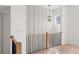 Modern hallway with wood accent wall, wood floors, iron and wood banister, and stylish pendant light at 235 W Marietta St, Canton, GA 30114