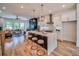 Open concept kitchen with a large island, pendant lighting, and seamless access to the living space at 235 W Marietta St, Canton, GA 30114