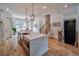 Gourmet kitchen with a center island, stainless steel appliances, and access to the staircase at 235 W Marietta St, Canton, GA 30114