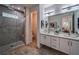 Modern bathroom boasts double vanity, marble tile, and a glass-enclosed shower for a spa-like experience at 235 W Marietta St, Canton, GA 30114