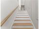 Bright staircase features wood treads and white risers, complemented by a natural wood handrail at 235 W Marietta St, Canton, GA 30114