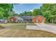 Charming single-story home featuring a brick facade, well-maintained lawn, and a concrete driveway at 3706 Bouldercrest Rd, Ellenwood, GA 30294