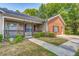 Inviting home with a cozy front porch, brick details, and well-manicured landscaping at 3706 Bouldercrest Rd, Ellenwood, GA 30294