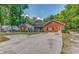 Attractive single-story home with brick accents, mature trees, and a spacious concrete driveway at 3706 Bouldercrest Rd, Ellenwood, GA 30294