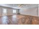 Bright and airy living room showcasing stylish flooring, a ceiling fan, and access to the backyard at 3706 Bouldercrest Rd, Ellenwood, GA 30294