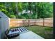 Fenced backyard with patio, black and white rug, and outdoor seating at 4175 Spring Valley Cir, Tucker, GA 30084