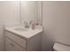 Bright bathroom vanity featuring a modern sink, white cabinets, and a large mirror at 4175 Spring Valley Cir, Tucker, GA 30084