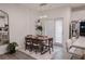 Dining room with wood table set for six next to bright modern kitchen at 4175 Spring Valley Cir, Tucker, GA 30084