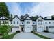 Charming townhomes featuring white exteriors, driveways, and well-maintained landscaping at 4175 Spring Valley Cir, Tucker, GA 30084