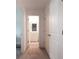 Hallway with carpeted floors and white walls that leads to the bathroom at 4175 Spring Valley Cir, Tucker, GA 30084