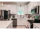Bright kitchen with stainless steel appliances, stylish backsplash, and white cabinetry at 4175 Spring Valley Cir, Tucker, GA 30084