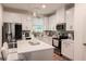 Bright kitchen with white cabinets, stainless steel appliances and island seating at 4175 Spring Valley Cir, Tucker, GA 30084