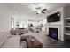 Open-concept living room with fireplace, TV, modern sofa and hardwood floors at 4175 Spring Valley Cir, Tucker, GA 30084