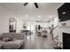 Open-concept living room with hardwood floors, modern furniture, and an open kitchen at 4175 Spring Valley Cir, Tucker, GA 30084