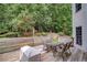 Back deck with table, chairs and grill, perfect for outdoor gatherings at 7071 Glen Cove Ln, Stone Mountain, GA 30087